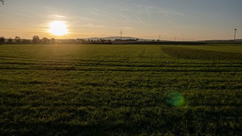 Scenic view of field against sky during sunset