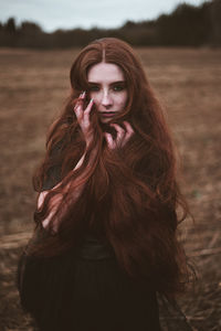 Portrait of young woman standing outdoors