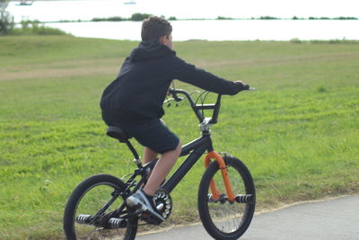 Man riding bicycle on field