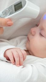 Close-up of baby boy sleeping on bed