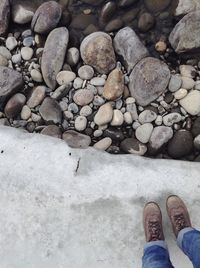 Low section of person standing on frozen lake