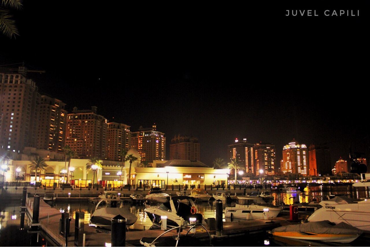 building exterior, night, built structure, architecture, illuminated, large group of people, real people, city, outdoors, travel destinations, city life, men, clear sky, sky, cityscape, people