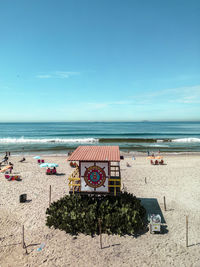 Scenic view of beach against blue sky