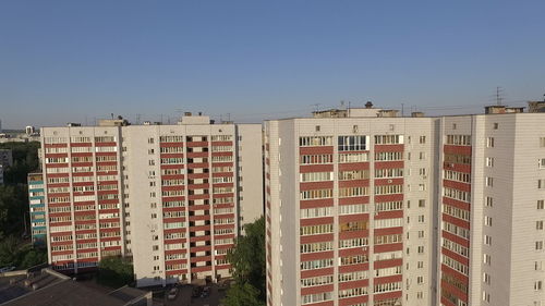 Residential buildings against clear blue sky