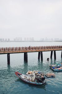 Boats in river with city in background