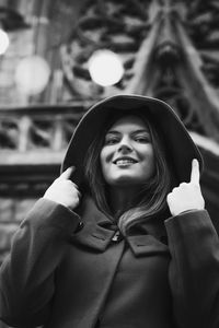 Close up pretty lady in hooded coat on street monochrome portrait picture