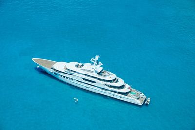 High angle view of ship sailing in sea against blue background