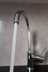 Close-up of faucet in bathroom