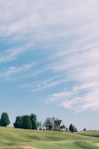 House by trees against sky