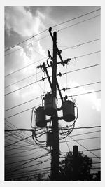 Low angle view of electricity pylon against sky