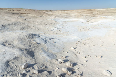 Scenic view of desert land against sky