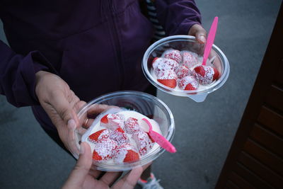 High angle view of woman holding ice cream