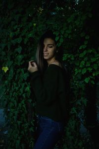 Teenage girl standing by plants