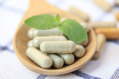 Close-up of pills in bowl on table