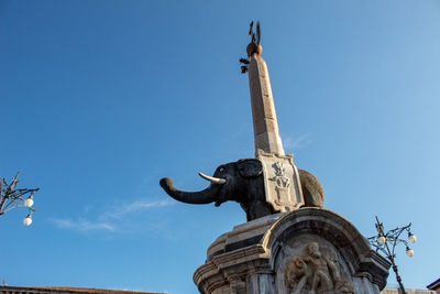 Low angle view of statue against sky