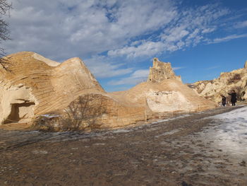 View of rock formations against cloudy sky