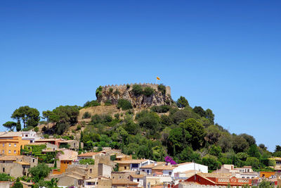 Townscape against clear blue sky in town