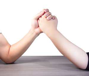Low section of woman against white background