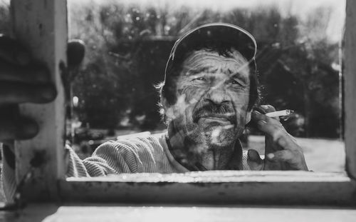 Portrait of man smoking cigarette