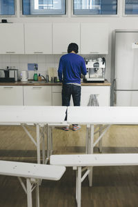 Man preparing coffee in office canteen
