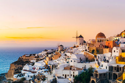 Buildings in city at sunset