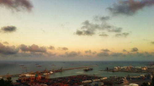 Boats in harbor at sunset