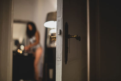 Close-up of woman standing by door