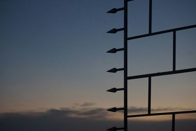 Low angle view of silhouette pole against sky at sunset