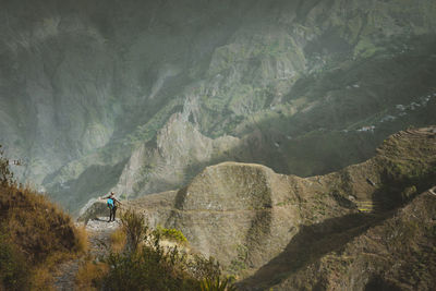 High angle view of woman standing on mountain