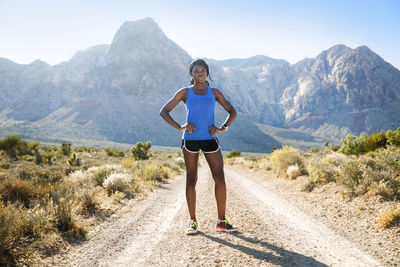 Full length of woman standing on mountain