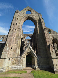 Low angle view of old ruin building against sky