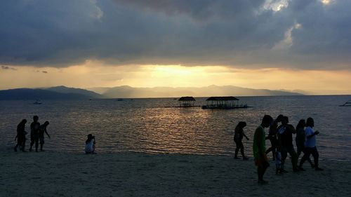 People on beach at sunset