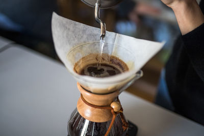 Close-up of hand preparing coffee