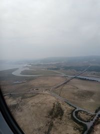 Aerial view of landscape seen through airplane window