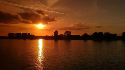 Scenic view of lake against sky during sunset