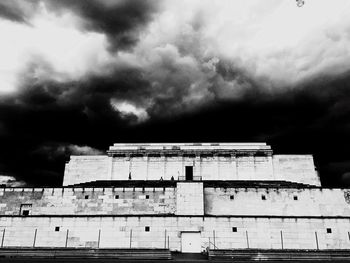 Low angle view of building against cloudy sky