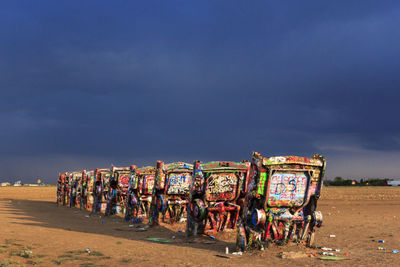 People at beach against sky