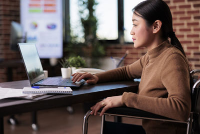 Young woman using laptop at home