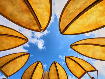 Low angle view of umbrellas against sky