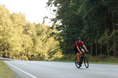 Man riding bicycle on road