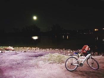 Man with bicycle at night