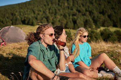 Young couple sitting outdoors