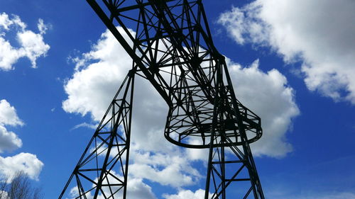 Low angle view of communications tower against sky