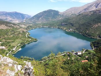 Scenic view of lake and mountains against sky