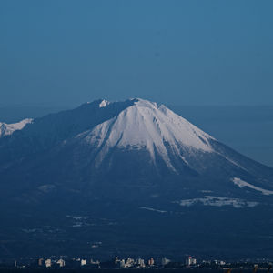 Scenic view of snowcapped mountains against clear sky