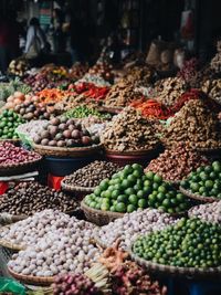 Various food in baskets for sale at market stall