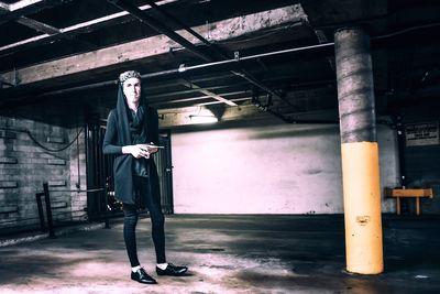 Trendy man standing in parking garage