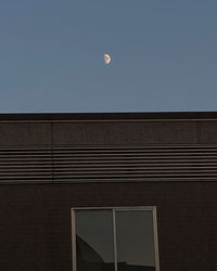 Low angle view of building against clear sky at night