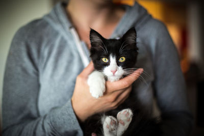 Close-up portrait of woman holding cat