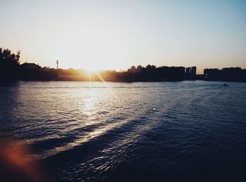 Scenic view of river against clear sky during sunset